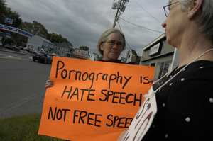 Protest against a pornographic video store in Northampton: protesters holding sign reading 'Pornography is hate speech, not free speech'