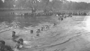Students submerged in the campus pond during the traditional rope pull