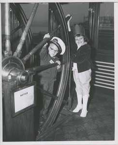 Boy and girl in wheelhouse on boat ride