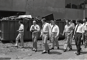 Mayor Raymond L. Flynn on a construction site with eight unidentified men