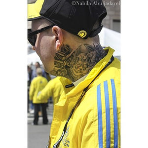 2013 Boston Marathon worker with neck tattoo