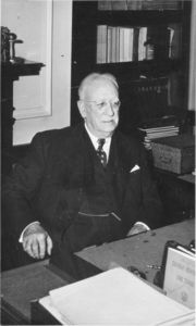 Suffolk University Law School Dean Frank L. Simpson (Law, 1942-1952), seated behind desk