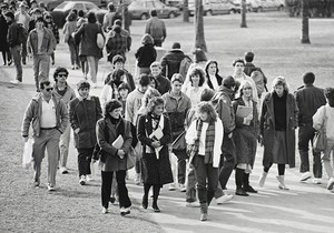 Students walking along pathway at Boston College, possibly during a tour
