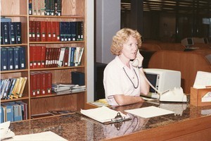 O'Neill Library interior: staff member answering phone at desk