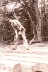 Albert Norris hewing beams with an adz for the bridge over the overflow waterfall at the Norris Reservation