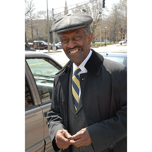 Reverend Michael E. Haynes stands beside his vehicle