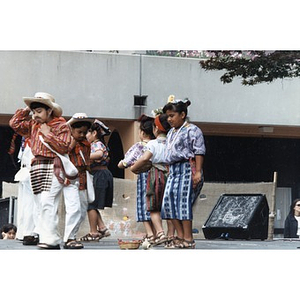 Children in traditional costumes perform on the outdoor stage at Festival Betances.