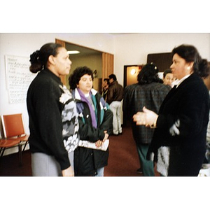 Women having a conversation before or after a community meeting held in the Inquilinos Boricuas en Acción offices.