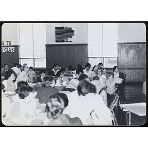 Children and adults sit around tables in an auditorium, looking to the front during a Boys' Clubs of Boston Awards Night