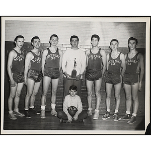 1949-1950 Roxbury Clubhouse basketball team posing with their trophy
