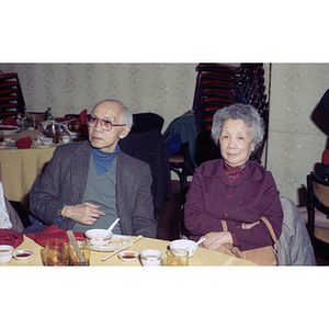 Man and woman sit at a restaurant table during a celebration of the Chinese New Year