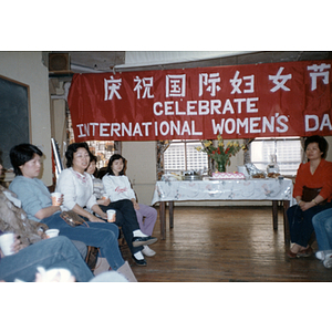 Guests and cake at an International Women's Day event