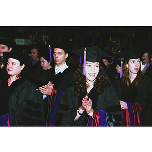 School of Law students clapping while standing during the School of Law commencement ceremony