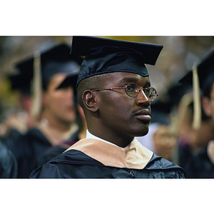 Graduate listening to speaker during commencement
