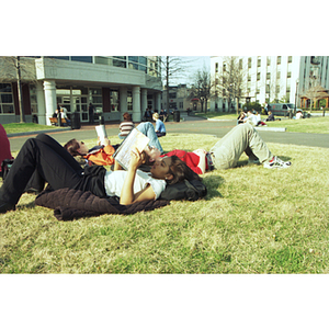 Students lay on the grass in Centennial Quad reading in the sun