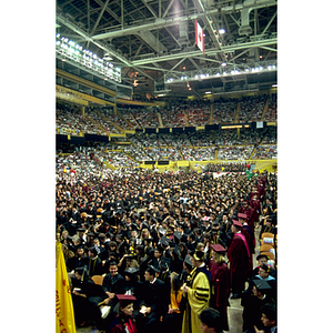 Graduates and guests seated during the commencement ceremony in Matthews Arena