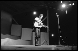 Bob Dylan performing on stage, Newport Folk Festival