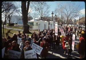 Antiwar protesters march past the White House with signs reading 'No more war, war never again' and 'Bring the GI's home now': Washington Vietnam March for Peace