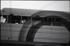 Free Spirit Press crew peering out bus windows