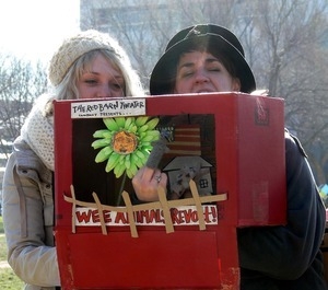 Protesters on the National Mall with puppet theater box, marching against the War in Iraq