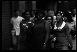 Beatles concert at Shea Stadium: three African American girls in a crowd of fans outside the stadium