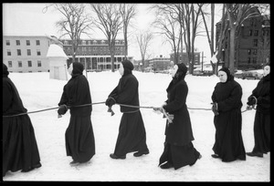 Protesters from Bread and Puppet Theater, hands bound and dressed in cloaks and masks, during a demonstration against the invasion of Laos at the Vermont State House