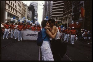 Women kissing in front the San Francisco Gay Men's Chorus at the San Francisco Pride Parade
