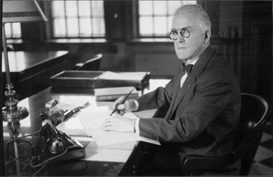 Hugh P. Baker sitting at his office desk