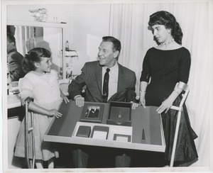 Unidentified man and clients displaying office supplies built at the institute