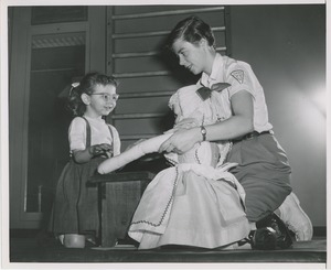 Physical therapist with young girl and doll