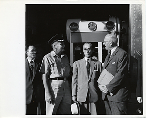 Mark Bortman with three unidentified men and medical equipment