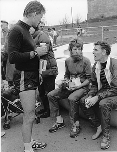 Mayor Raymond L. Flynn in running gear at Castle Island, South Boston speaking to other unidentified runners