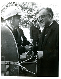 Cardinal Medeiros shaking hands with police officer