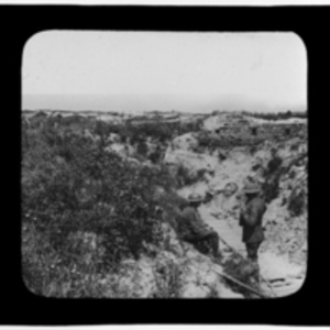 Soldiers standing beside a boardwalk