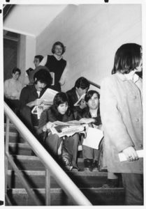 Suffolk University students standing and sitting in stairwell