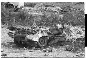 Bomb explosion at Ballydugan Road, Downpatrick where four UDR men were killed by IRA culvert bomb. Shots show mangled army vehicle and general scene