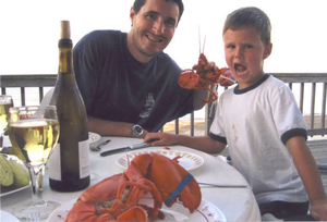 Ned and Jack Demong enjoying a lobster dinner on Humarock Beach