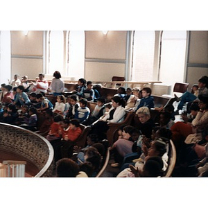 Children in the balcony area of the Jorge Hernandez Cultural Center watching a performance.