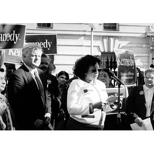 Jovita Fontanez at the microphone during an outdoor rally in support of Senator Ted Kennedy.