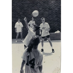 Women playing volleyball.