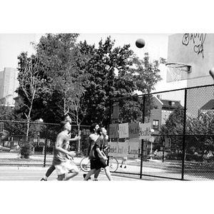 Inquilinos Boricuas en Acción/PAL Youth Health Basketball League shooting hoops.