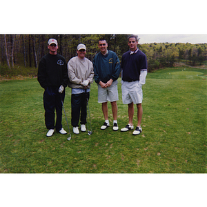 A four-man golf team posing at the Charlestown Boys & Girls Club Annual Golf Tournament