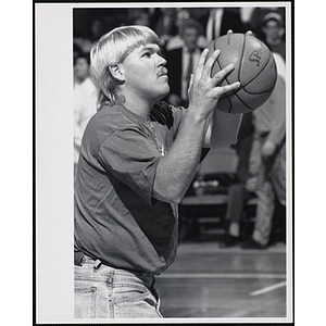 PGA golfer John Daly preparing to shoot a basketball at a fund-raising event held by the Boys and Girls Clubs of Boston and Boston Celtics