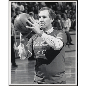 Former MLB pitcher Mark Wiley holding a basketball ready to shoot at a fund-raising event held by the Boys and Girls Clubs of Boston and Boston Celtics