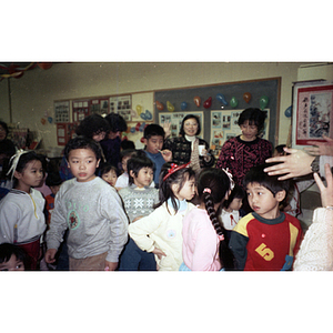 Group of children is gathered at the Chinese Progressive Association during a celebration of the Lunar New Year