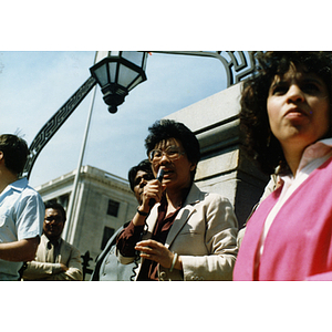 Speaker on the steps of the Massachusetts State House at a rally for bilingual education in schools