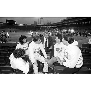 Jack Grinold sits with five Northeastern students at Fenway Park