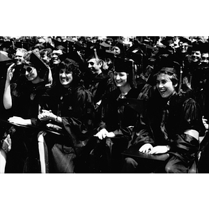 Four female law school graduates smile at commencement