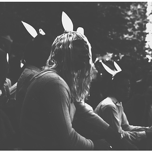 A student in a wig and bunny ears smokes a cigar as he watches the Mayor of Huntington Avenue campaign demonstrations