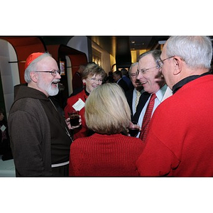 Cardinal O'Malley speaking with guests at the Beanpot Reception